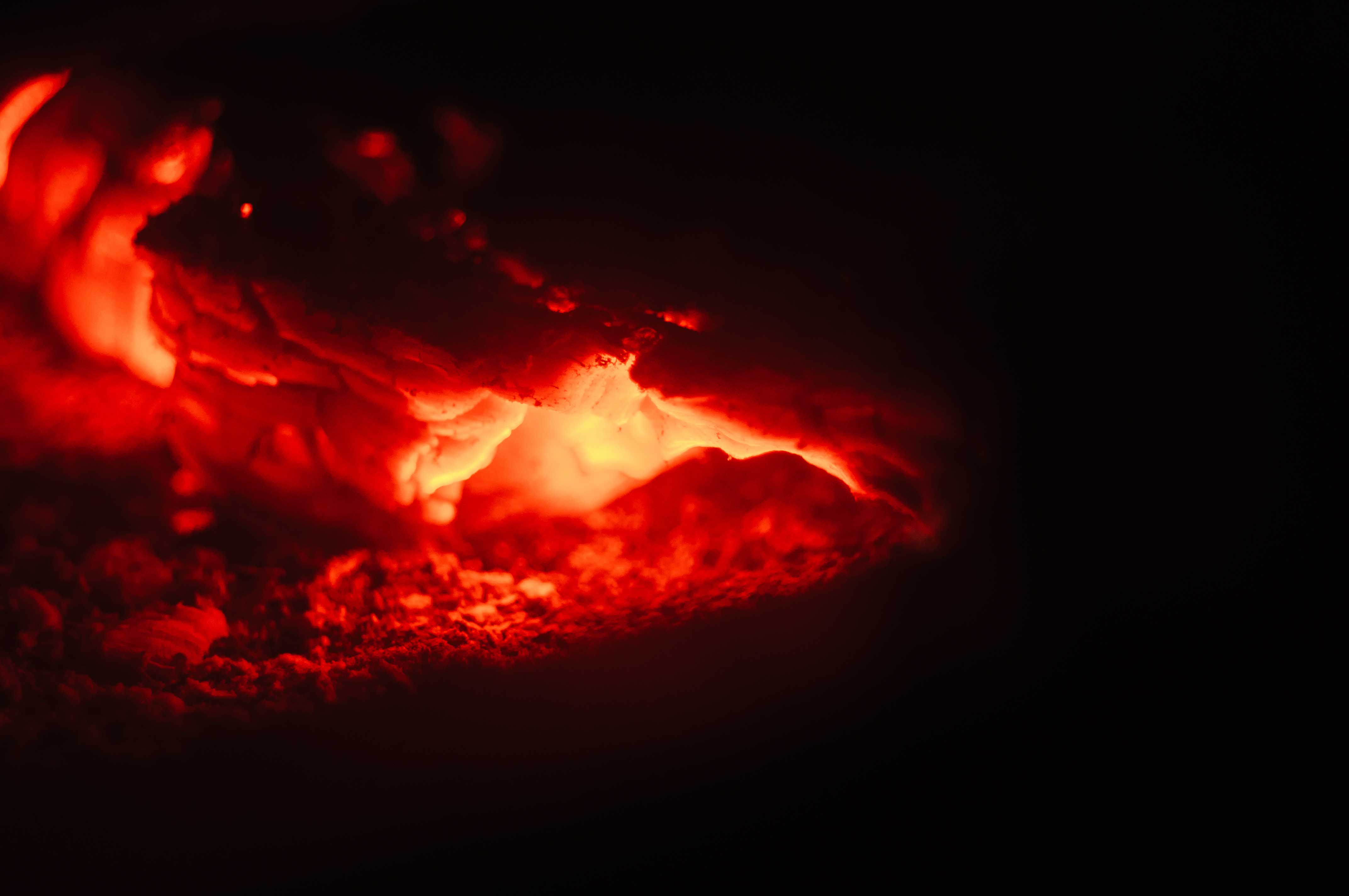 A closeup shot of red fire on a black background - for backgrounds